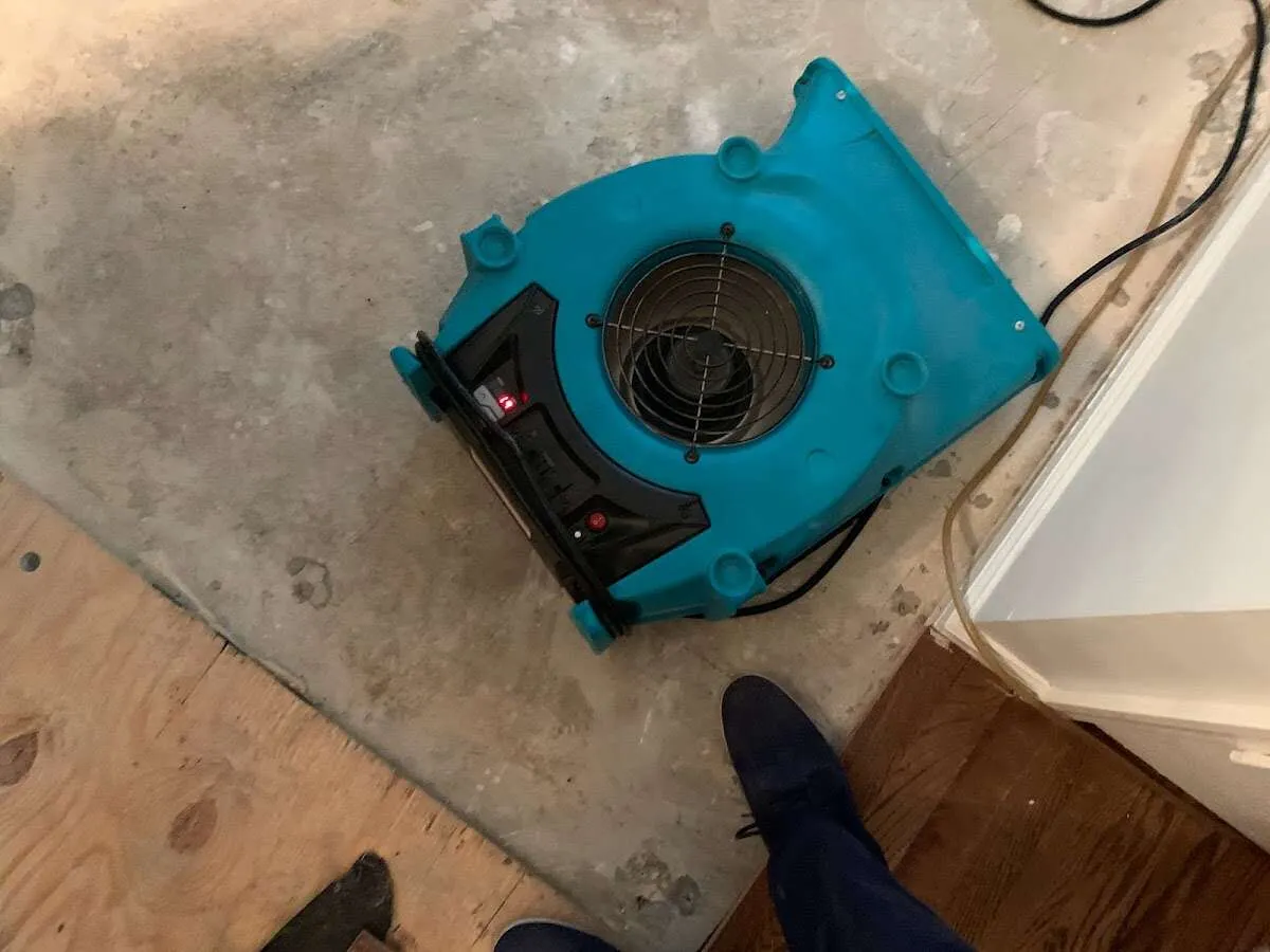 Air mover drying subfloor during Commercial Water Damage Restoration in Dowagiac